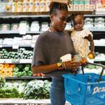 women grocery shopping with baby